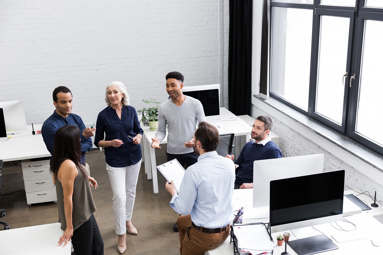 Image of a team of people talking in an office